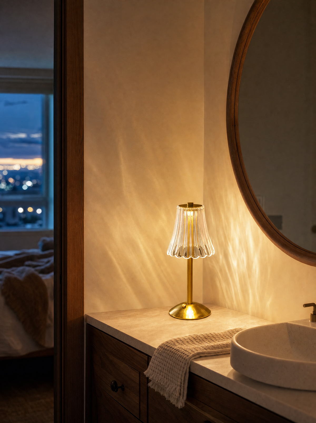 Crystal-cut table lamp with tulip shade on a bathroom vanity