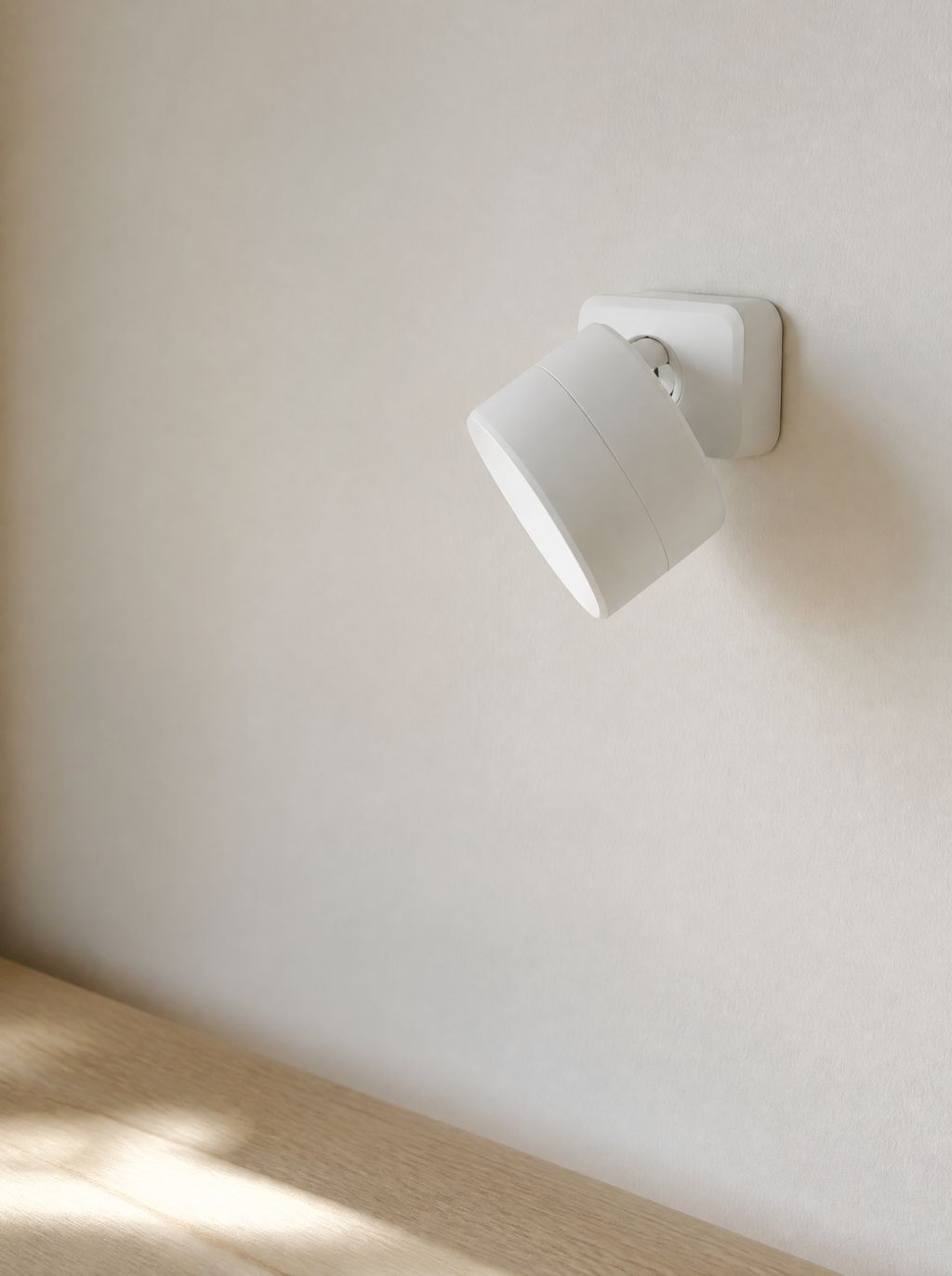 Stick-on wall sconce on its square adhesive base, daylight