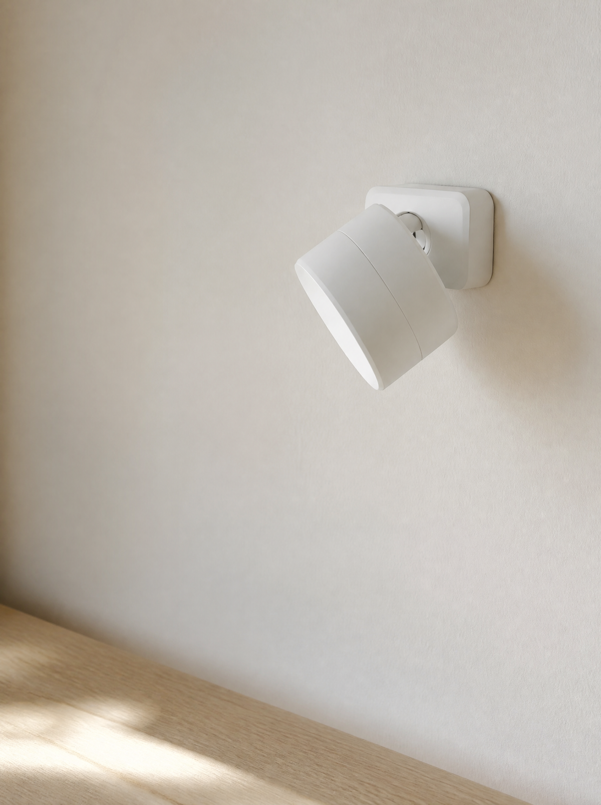 Stick-on wall sconce on its square adhesive base, daylight