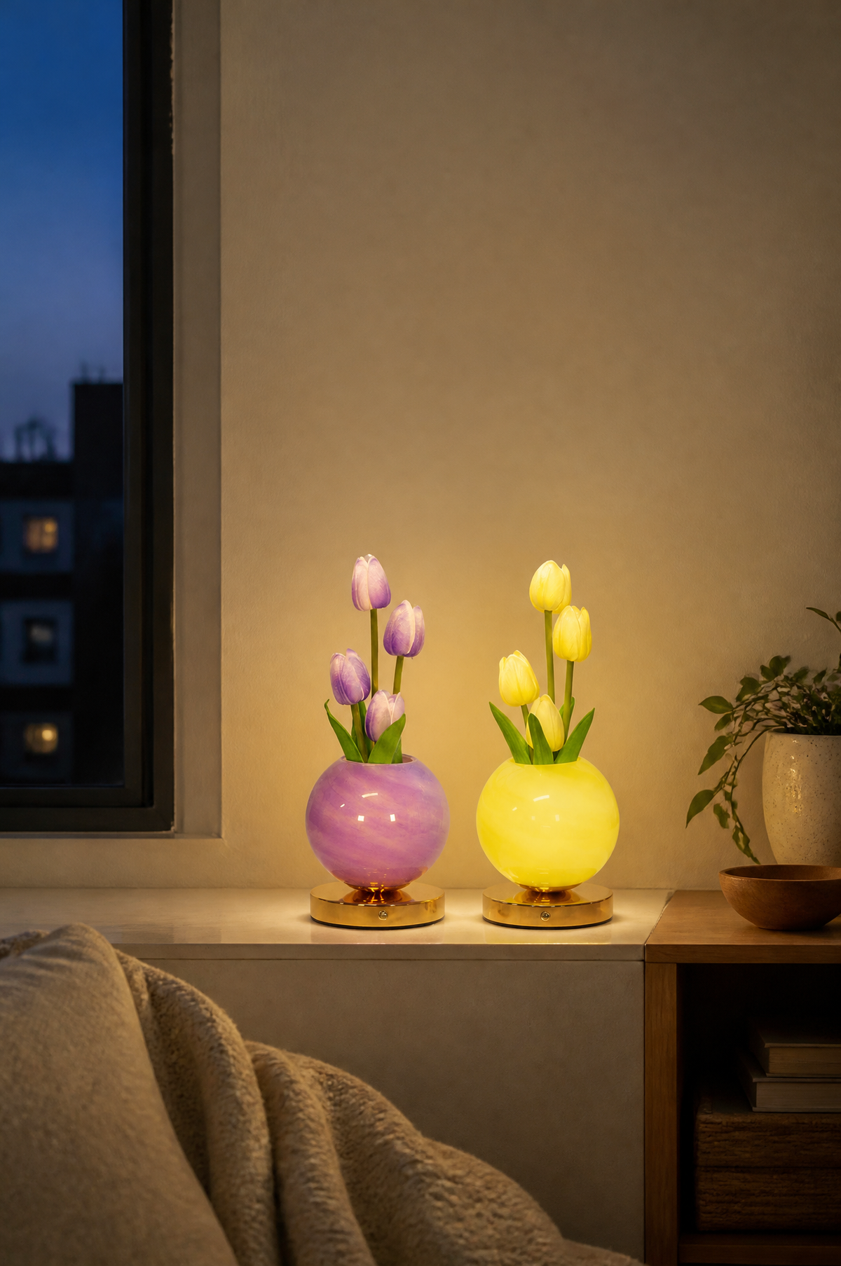Lilac and yellow tulip lamps glowing on a windowsill
