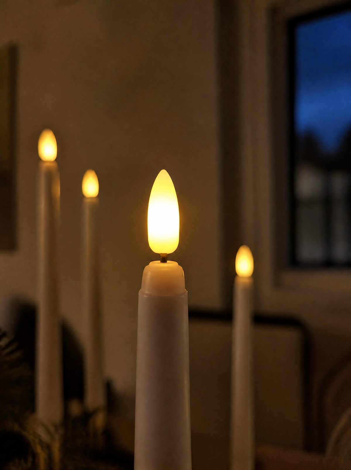Close-up of a flameless taper candle flame tip