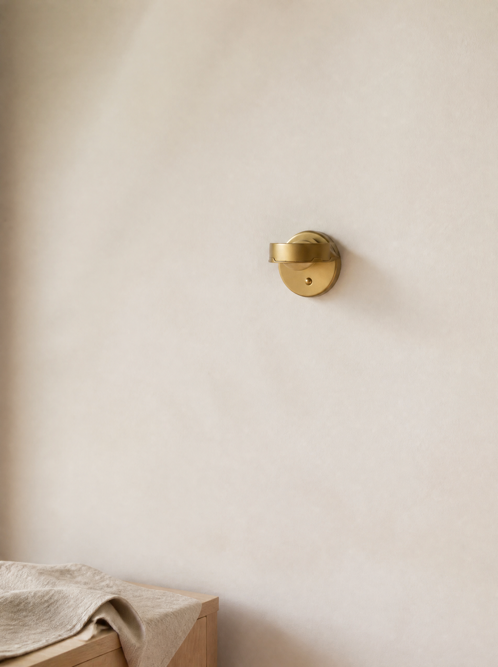 Small gold stick-on sunset wall light in daylight